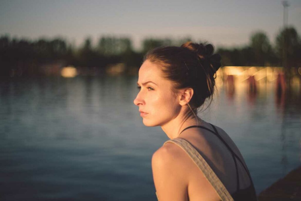 stressed employee looking into distance in front of lake